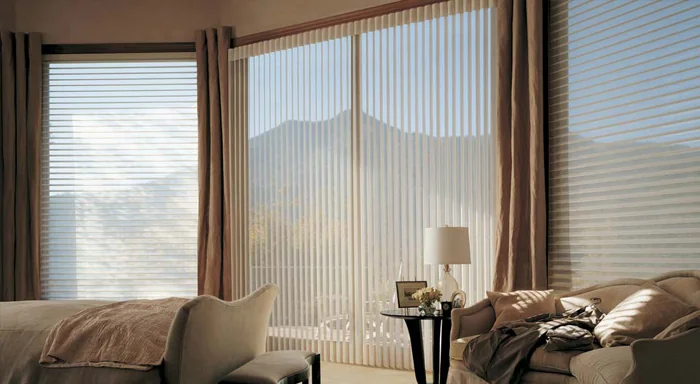 Vertical sheer shades across a wide living room window