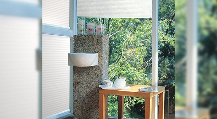 Top-down cellular shades providing privacy while leaving a garden view